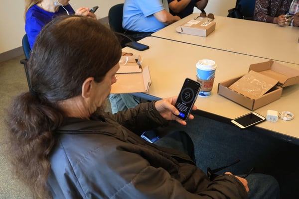 Close-up of a participant setting up Face ID on a smartphone.