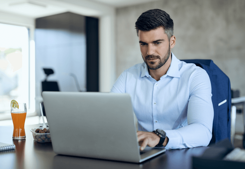 male-entrepreneur-using-computer-while-working-office 1 (1)